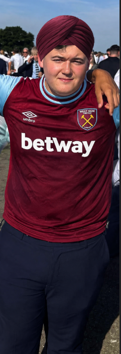 Community member wearing a West Ham shirt and maroon turban